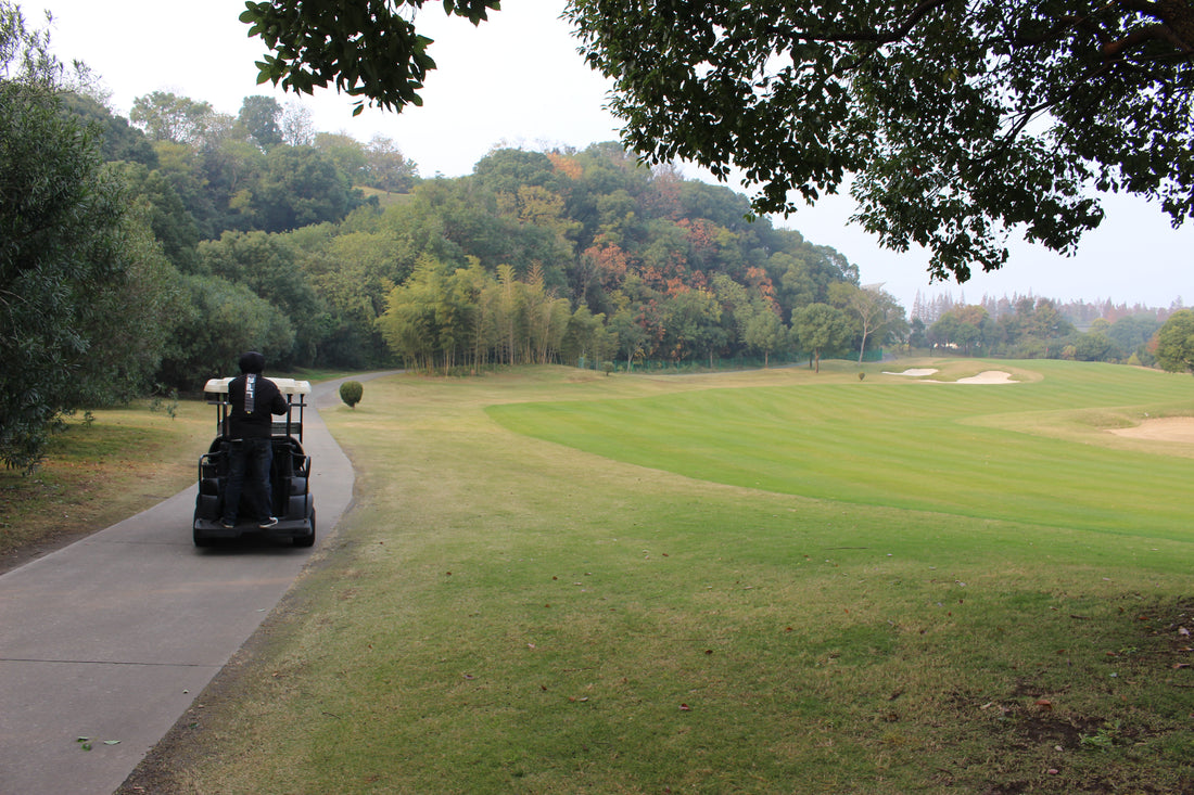 golf course with golf cart on side trail