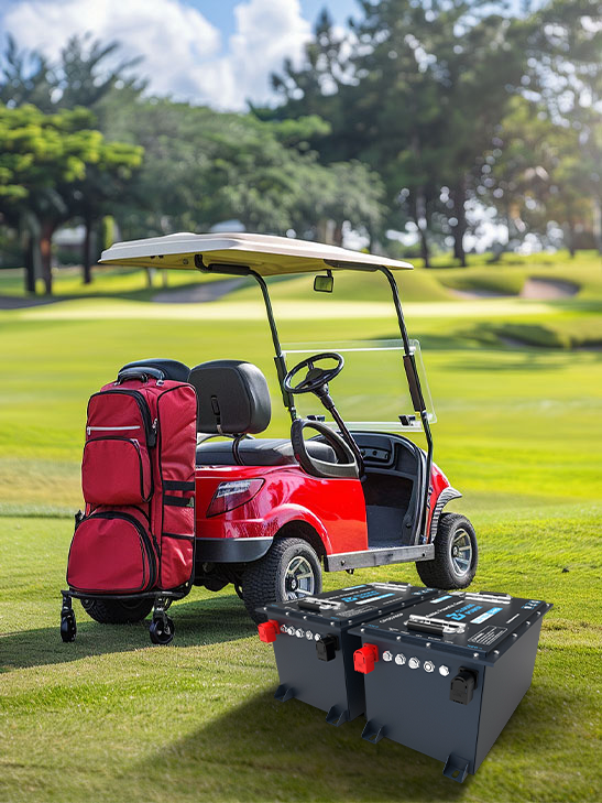 Red golf cart with a large red bag on a golf course, accompanied by two black lithium battery packs.