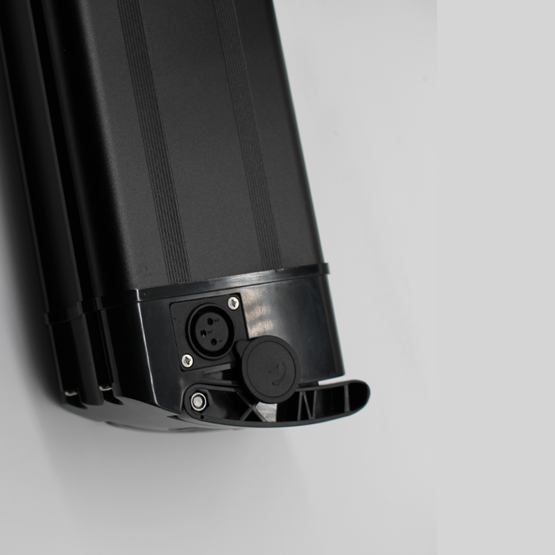 Black electric bike battery with connectors on a light gray background