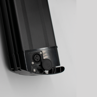 Black electric bike battery with connectors on a light gray background